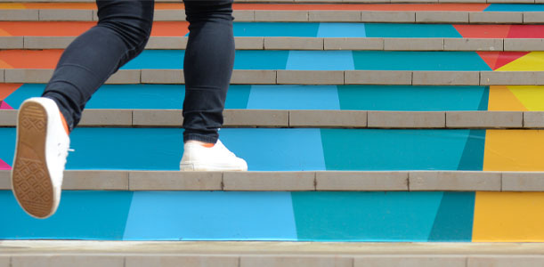 Man walking up colorful steps